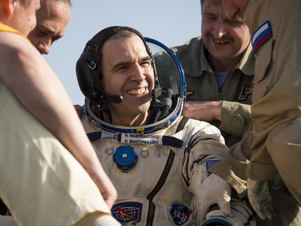 Expedition 39 Flight Engineer Rick Mastracchio of NASA is helped out of the Soyuz capsule.