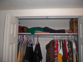My 4 year old planking a closet shelf.