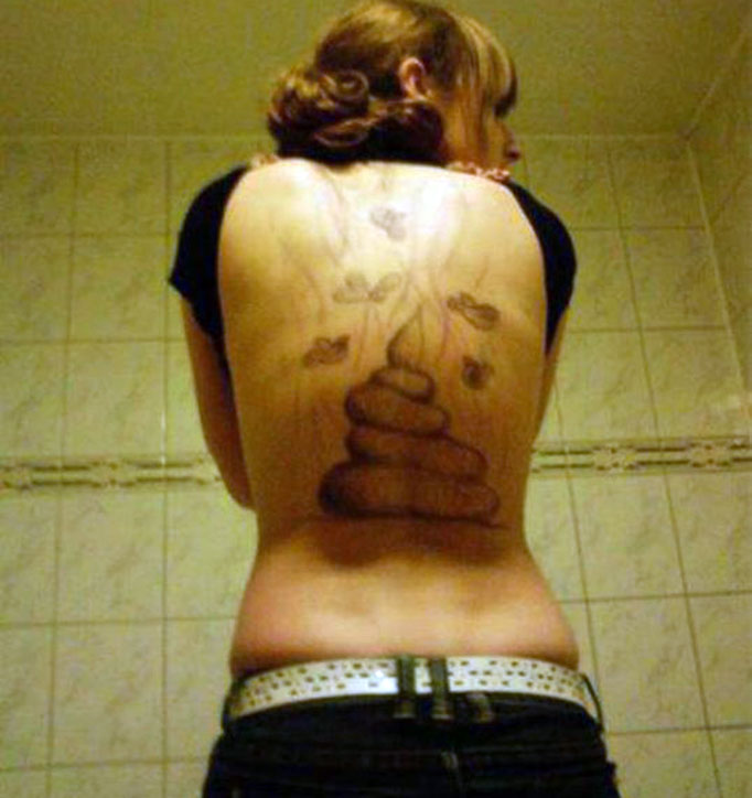 A FURIOUS woman is suing her ex-boyfriend after he tattooed a steaming poo on her back.
The woman, Rossie, wanted a scene from the Narnia trilogy inked on her back.
Instead she was left with a pile of excrement with flies buzzing around it.
Tattoo artist Ryan turned rogue after discovering that Rossie had cheated on him with his best friend.
