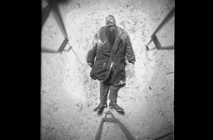 New York Police Department Evidence photo. Homicide victim - overhead view, ca. 1916-1920. At the corners, note the legs of the tripod supporting the camera above the body.
