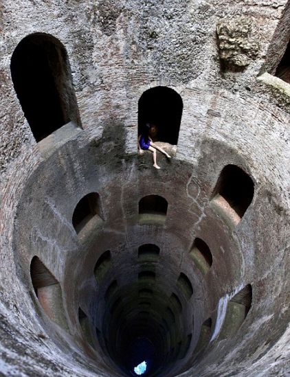 Ahn sits on the ledge of an alcove in Italy.