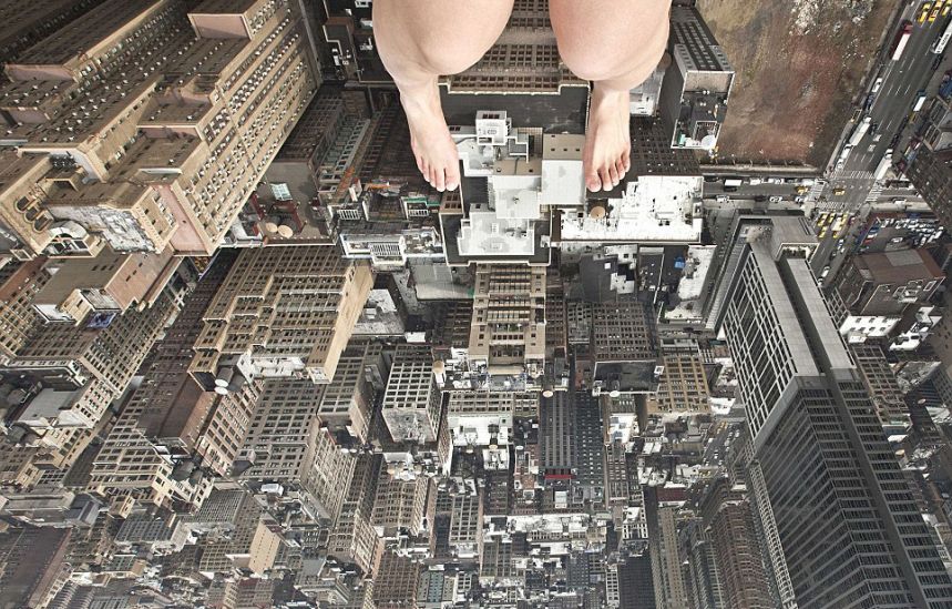 Jun Ahn photographs her feet as she sits on the edge of a rooftop overlooking the skyscrapers of New York City.