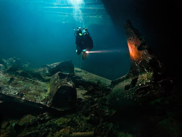 A6M Zero fighters and a tail from a Mitsubishi G4M Bomber inside of the Fujikawa Maru.