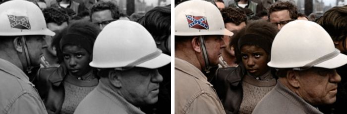 A Civil Rights demonstration in the 60s, an African-American woman stares down a man donning the Confederate flag on his hardhat 1963