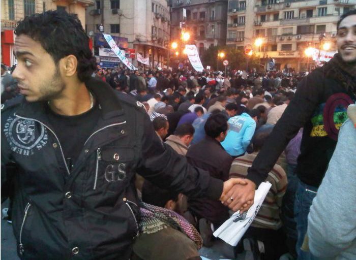 Christians protect Muslims during prayer in the midst of the 2011 uprisings in Cairo, Egypt