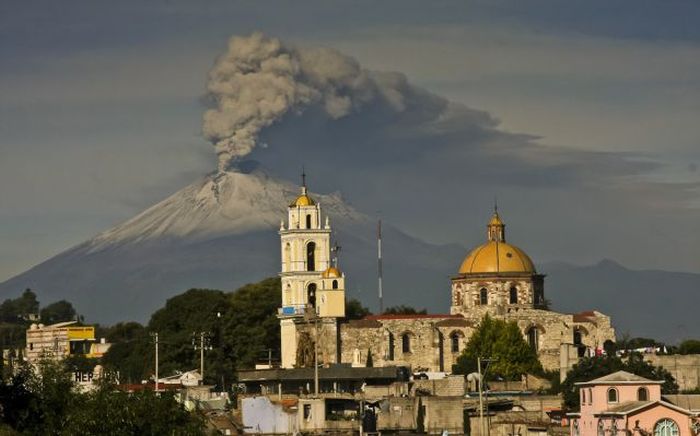 Ash spews from Mexico's Popocatepetl volcano, some 55 km from Mexico City, as seen from San Damian Texoloc in the Mexican central state of Tlaxcala. During the weekend authorities have raised the alert level to 'Yellow Phase Three,' the fifth of a seven-stage warning system, restricting access to an area of 12 km around the volcano while preparing evacuation routes and shelters.