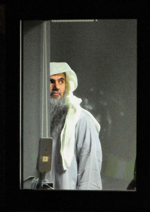 Radical cleric Abu Qatada L prepares to board a plane at RAF Northolt which will take him to Jordan, after he was deported from the UK to face terrorism charges in his home country in London, England.