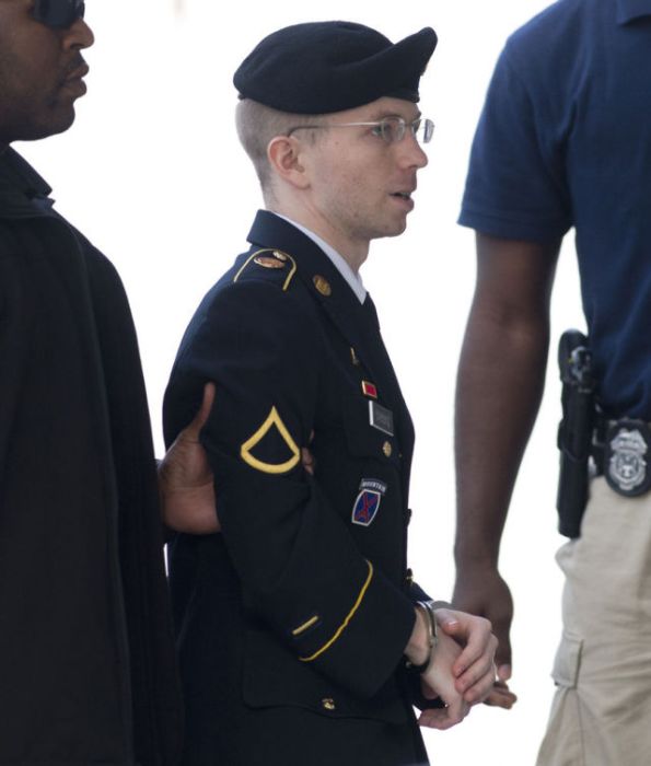 US Army Private First Class Bradley Manning arrives alongside military officials at a US military court facility to hear his sentence in his trial at Fort Meade, Maryland.