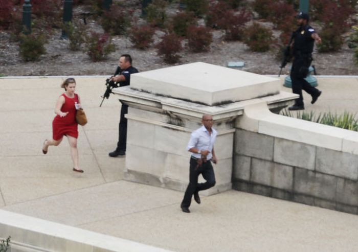 Police close in on the U.S. Capitol as people run for cover after reports of a shooting on Capitol Hill in Washington, DC. The US Capitol and the White House were placed on lockdown after an 'active shooter' situation was r