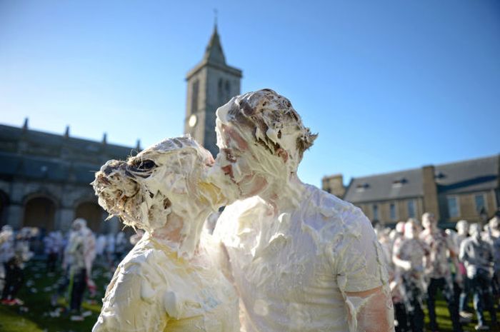 Students from St Andrew's University indulge in a tradition of covering themselves with foam to honour the 'academic family' in St Andrews, Scotland. Every November the 'raisin weekend' which is held in the university's St Salvator's Quadrangle, is celebrated and a gift of raisins now foam is traditionally given by first year students to their elders as a thank you for their guidance and in exchange they receive a receipt in Latin.