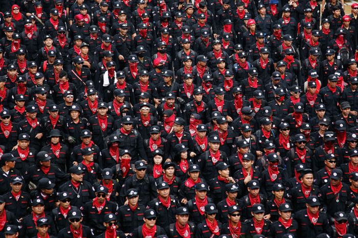 Tens of thousands of workers and labor activists march through the central business district in Jakarta, Indonesia. Protestors were demanding the implementation of higher minimum wages and better working conditions.