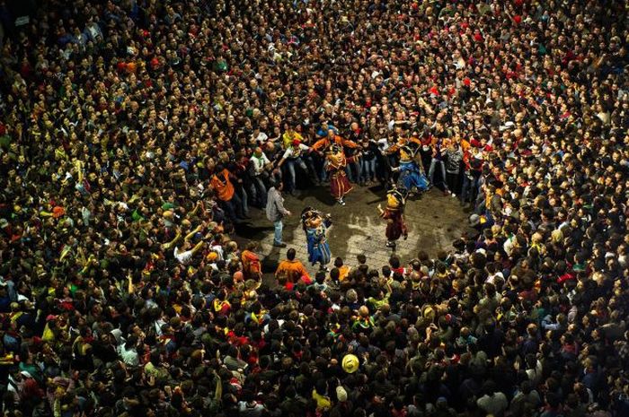 Revelers surround the 'Nans Vells', 'old dwarves' in Catalan, during the first day of 'La Patum' Festival in Berga, Spain. The Patum festival's roots are found in the theatrical performances of the Middle Ages and is held in the town of Berga each year during the week of Corpus Christi.