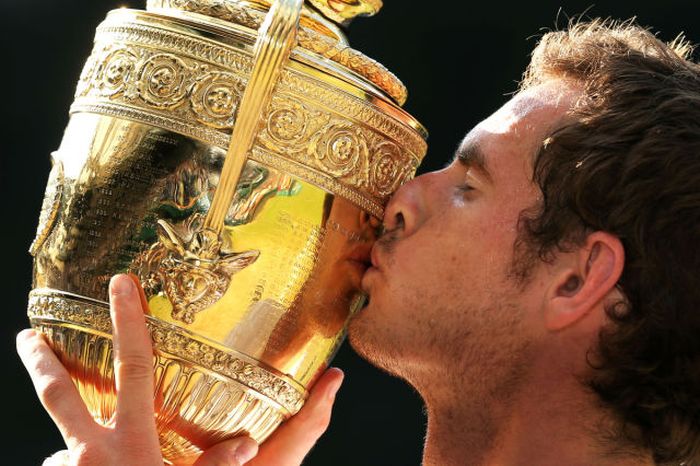 Andy Murray of Great Britain kisses the Gentlemen's Singles Trophy following his victory in the Gentlemen's Singles Final match against Novak Djokovic of Serbia on day thirteen of the Wimbledon Lawn Tennis Championships at the All England Lawn Tennis and Croquet Club in London, England.