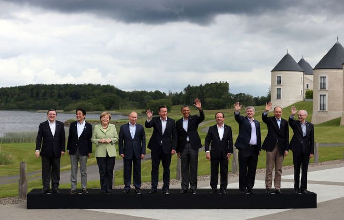 Leaders L-R President of the European Commission Jose Manuel Barroso, Japanese Prime Minister Shinzo Abe, German Chancellor Angela Merkel, Russia's President Vladimir Putin, Britain's Prime Minister David Cameron, US President Barack Obama, French President Francois Hollande, Canadian Prime Minister Stephen Harper, Italian Prime Minister Enrico Letta and European Council President Herman Van Rumpuy, stand for the family group shot at the G8 venue of Lough Erne .