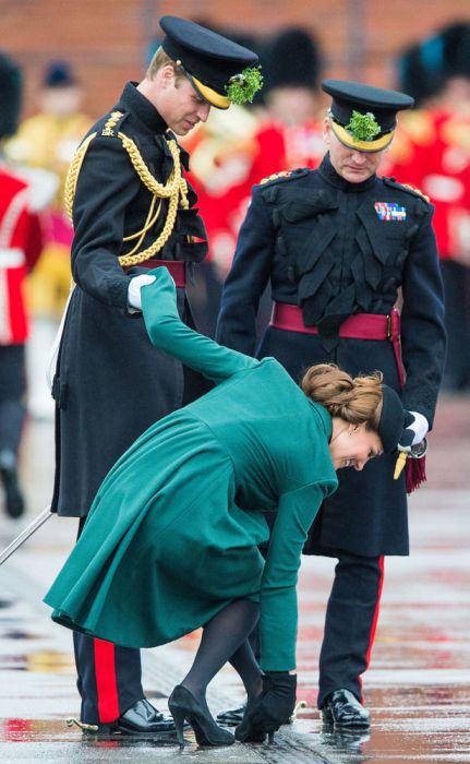 Duchess of Cambridge gets her shoe stuck in the grating and is helped by Prince William, Duke of Cambridge as they visit the Irish Guards' St Patrick's Day Parade at Mons Barracks in Aldershot, England.