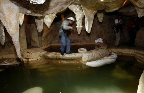 A man-made cave with a hot tub.