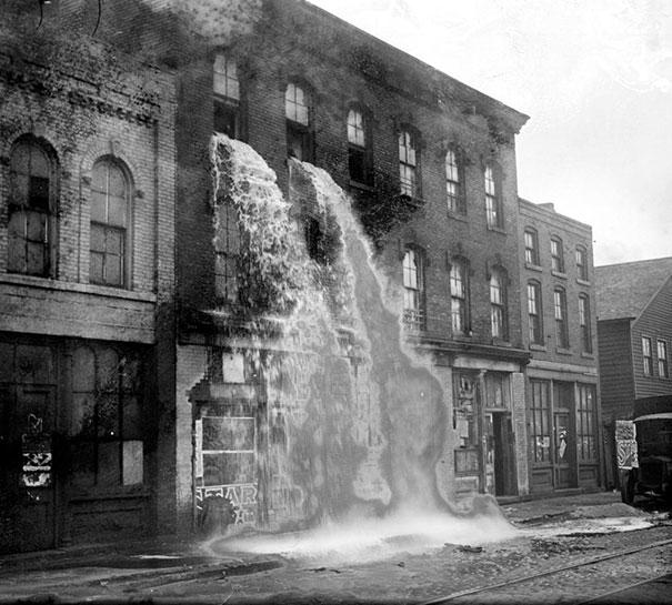 Illegal alcohol being poured out during Prohibition, Detroit, 1929