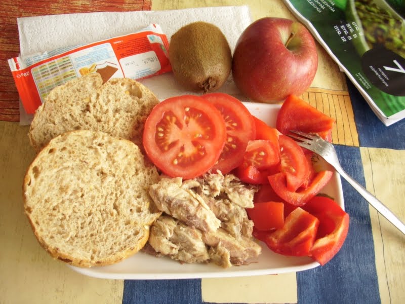 Country: Slovakia. Contents: Smoked mackerel, bread, red pepper and tomato salad, kiwi, apple, and a milk cake.