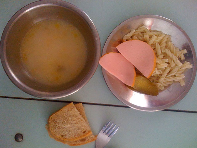 Country: Buchach, Ukraine. Contents: Soup, macaroni, pickle, bread, sliced hot dog