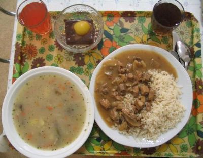 Country: Czech Republic Prague. Contents: Soup, rice, chicken, dessert is that egg on top?, juice and hot tea.