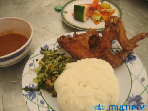 Country: Tanzania. Contents: Ugali, chicken, greens, dipping sauce, watermelon salad.