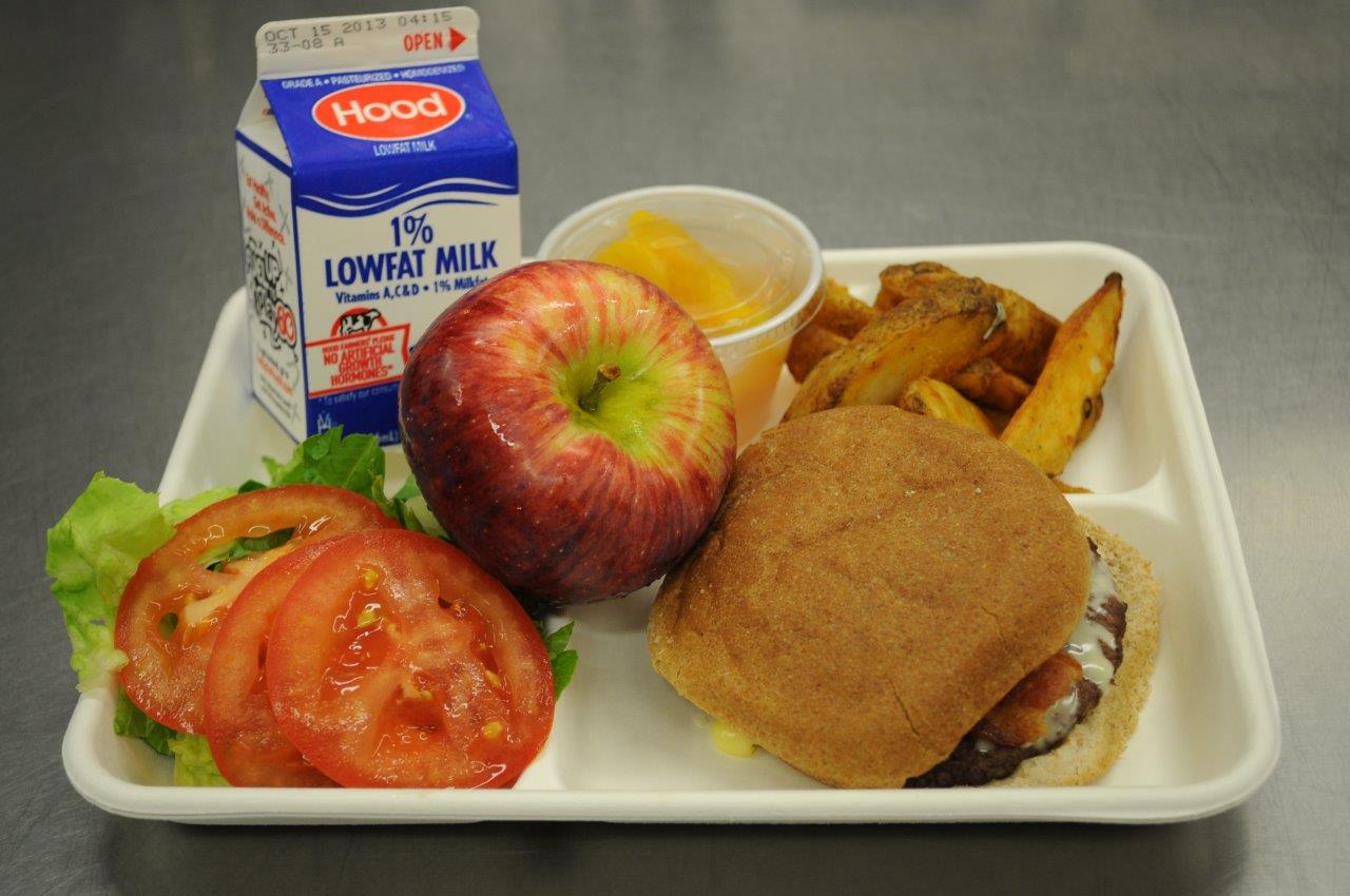Country: USA. Contents: Cheeseburger, french fries, salad, milk, apple, peaches