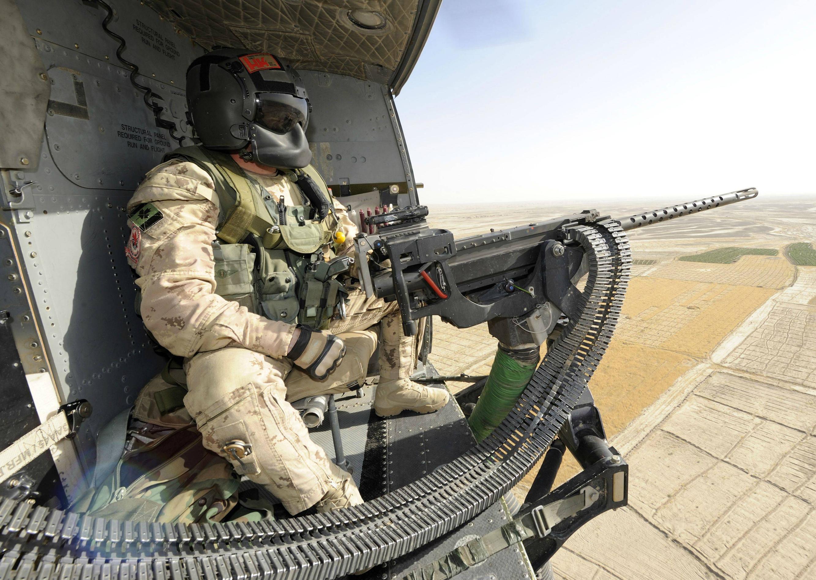 Canadian Door Gunner sits back in his CH-146 Griffon helicopter