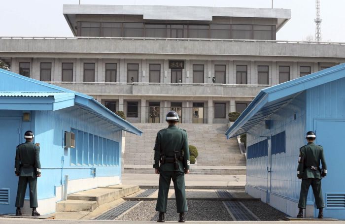 The South Koreans stand partially hidden to present less of a target, and stand well away from the actual border, as there have apparently been instances of guards being pulled and abducted into the North. All the SK guards are at least 58242 78243, and have a black belt in Tae Kwan Do or Judo.