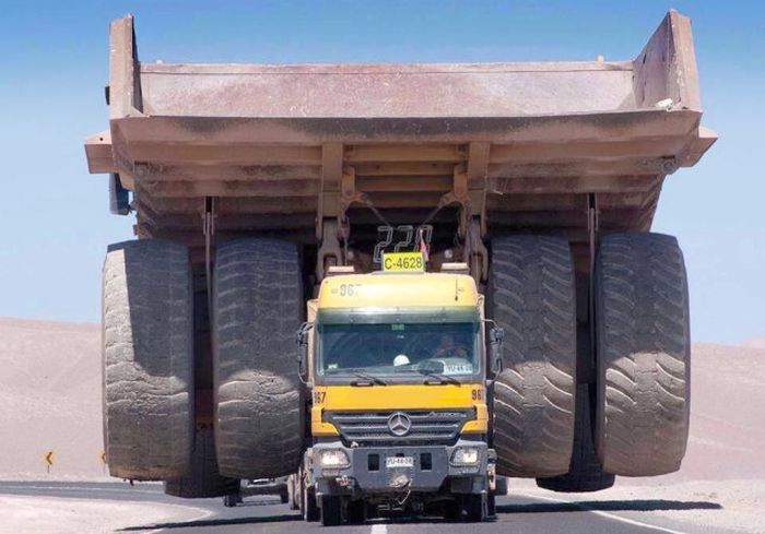 A regular truck transporting one of those massive mining trucks