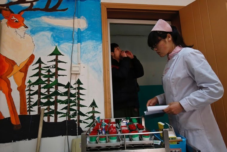 A nurse distributes medicine at the Daxing centre.
