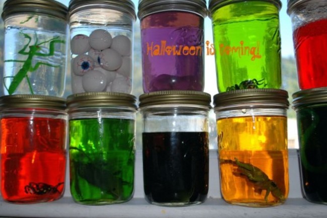 Repurpose glass pickle, baby food, or spaghetti sauce jars as freakish science experiments. Just fill with water, add a few drops of non-toxic food coloring, and drop in food, animal toys or other strange objects.