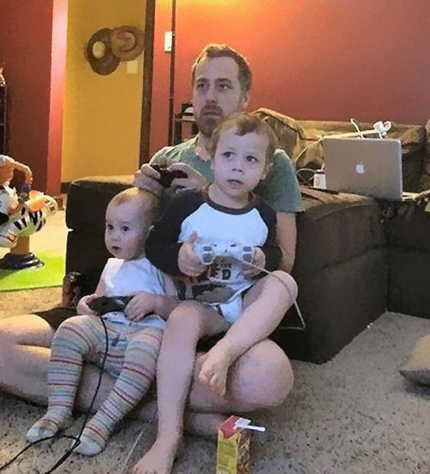 dad playing video games with baby