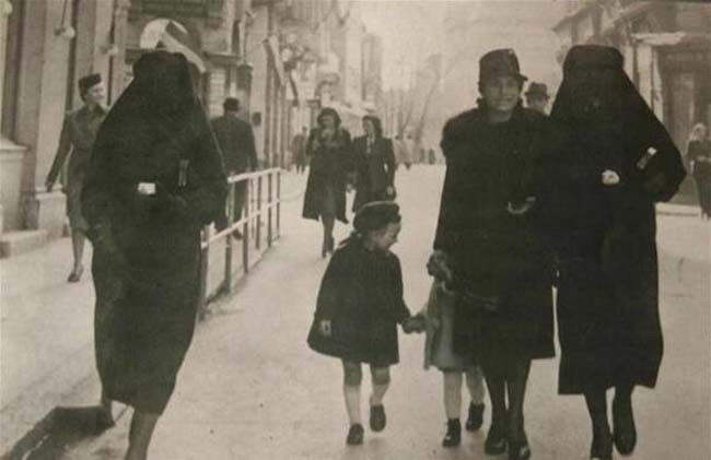 A Muslim woman covers the yellow star of her Jewish neighbour with her veil to protect her from prosecution. Sarajevo, former Yugoslavia. 1941