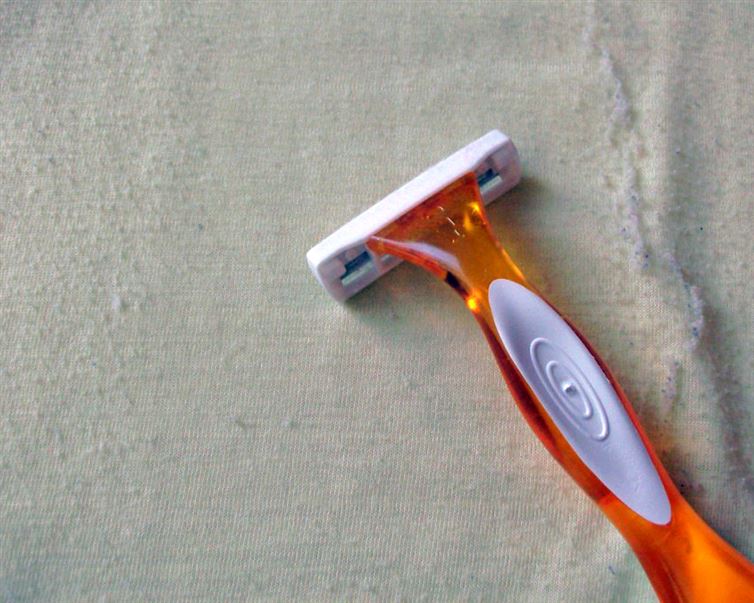 Use a razor to remove the pills from your sweaters
