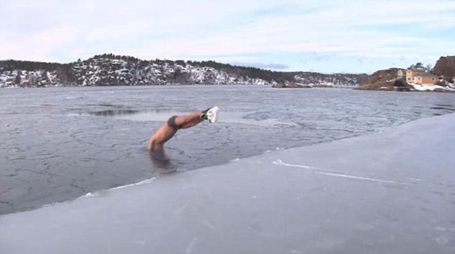 This guy taking a nice refreshing dip in a frozen lake