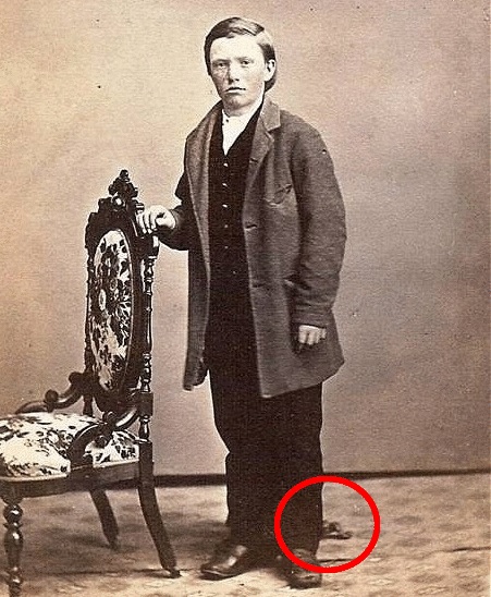 This boy is also dead, but that's not what he's here to demonstrate. We've established that Victorian people photographed their dead for posterity before holding any sort of funeral services for their loved ones, but what's interesting about this photo is the detail near his foot.