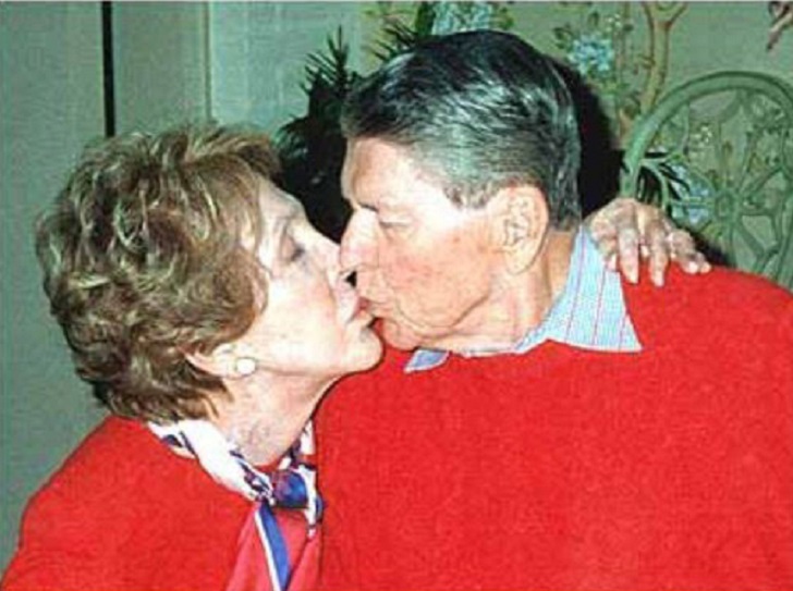Ronald Reagan (February 6, 1911 – June 5, 2004) – Ronald Reagan passed away in his home after a bout of pneumonia, complicated by Alzheimer’s Disease. This is one of the last photos taken of him, kissing his wife, Nancy. They were married for 52 years.