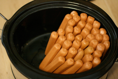 Cook hot dogs for all your guests at once by using a crock pot.
