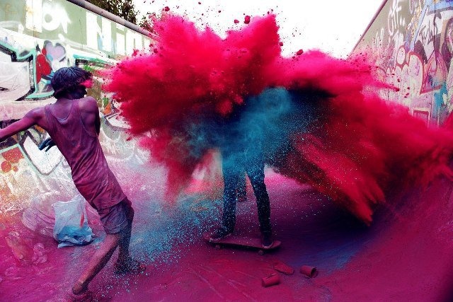 People Gather in Public Spaces and Run around, Chase Each Other, and Dance While Throwing Handfuls of Colored Dry Powder and Dyed Water at One Another