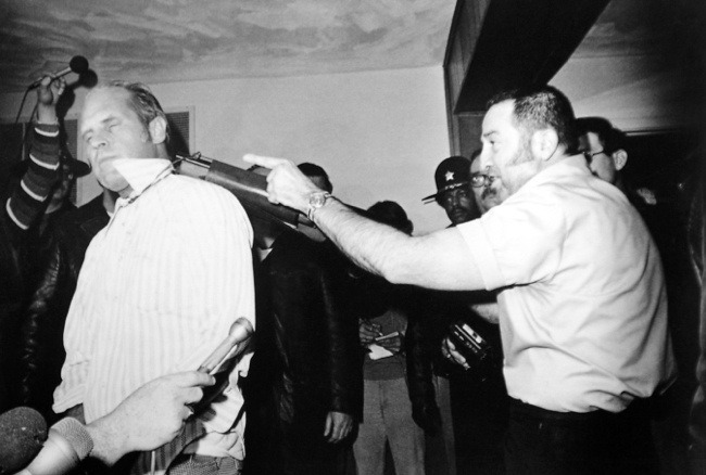Richard O. Hall is held hostage by Tony Kiritsis with a sawed-off shotgun during a live broadcast in Indianapolis, 1977. The gun was rigged so that if Kiritsis was killed or if Hall tried to escape he would be shot.