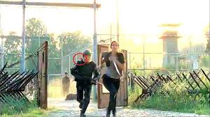 When Glenn is with Tara and getting ready to move out, he puts on his helmet and you can see it is strapped on. When the shot changes, he swings the fence open and you can see his strap is loose. The camera angle changes again and the strap is back on again.