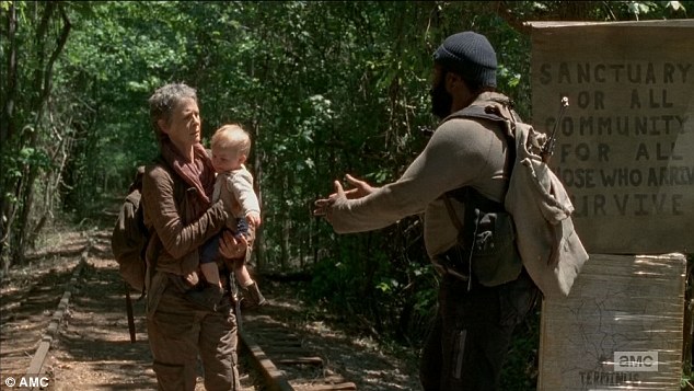 When Tyreese and Carol are walking down the railroad tracks towards Terminus, they encounter a herd of walkers coming out of the woods. One of the first walkers to cross the tracks is a male walker wearing a burgundy sweatshirt with a rip in the middle. When gunfire erupts at Terminus, the walkers turn their attention towards it. In the next shot when they start to head towards the sound, we see the same male walker now in the middle of the herd yet to cross the tracks. Next shot after that, we again see him at the front of the pack.