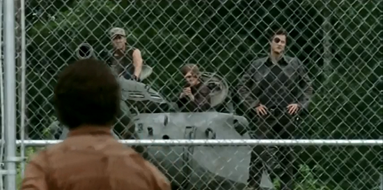 After The Governor shows up at the prison with his arsenal, Hershel and Michonne are taken out of the vehicles and placed kneeling on the grass side by side, about 1 arms length apart from each other. But when Rick makes his way down to the fence to talk with The Governor, Hershel and Michonne are now about 4 arms lengths away from each other. This goes back and forth for a few shots.