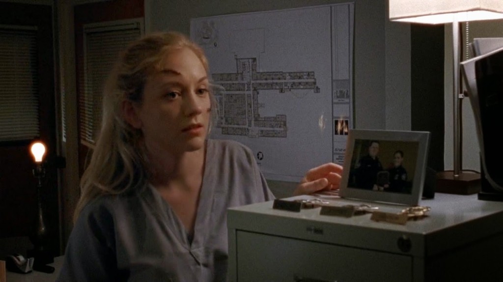 When Beth is looking for a key in Officer Dawn’s office, she encounters Joan lying dead in the office from bleeding out, apparently from suicide with a pair of surgical scissors. Her left hand is covered in blood. But when Officer Gorman enters the room and Joan starts to turn into a walker, the blood on her hand has disappeared.