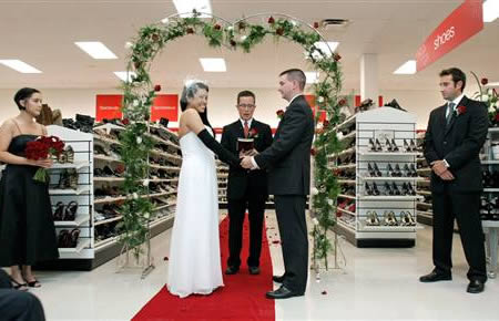 The couple who got married at T.J. Maxx:
Who doesn't get excited about the prospect of bagging a bargain? Bride Lisa Satayut decided to combine that feeling with her excitement over bagging her beau. Explaining that T.J. Maxx is her “happy place,” Satayut married Drew Ellis in the size 8 shoe aisle of a T.J. Maxx store in Mt. Pleasant, Mich. The bride — a self-proclaimed “'Maxxinista” — wore a strapless white chiffon gown, with long black gloves and bright green gladiator-style sandals. A widened aisle, vine-covered arch and white chairs with red bows highlighted the traditional ceremony that included string music, display-dodging cameramen — and curious shoppers who stopped bargain hunting long enough to watch.