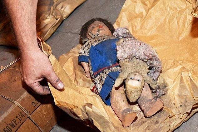 Rudi's father had wrapped these dolls in paper to preserve them over the years.