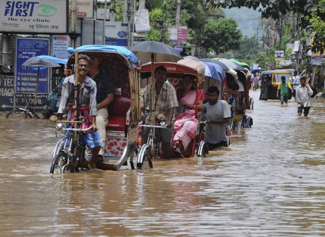 Heavy rains have flooded the Indian city of Guwahati. Yet people still have to get to work.