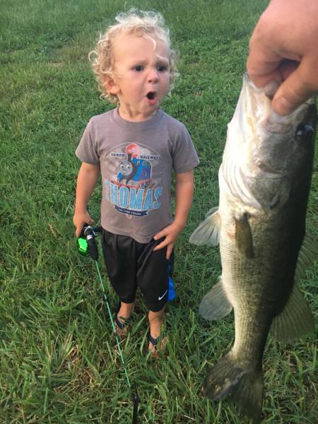 kid reacting to seeing a fish caught