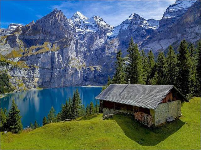 Beautiful house on the edge of a crips blue lake. probably in Finland or Switzerland.