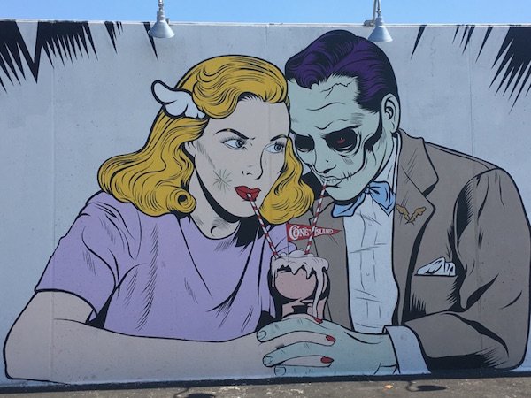 Cartoonish couple enjoying a milkshake as a mural.